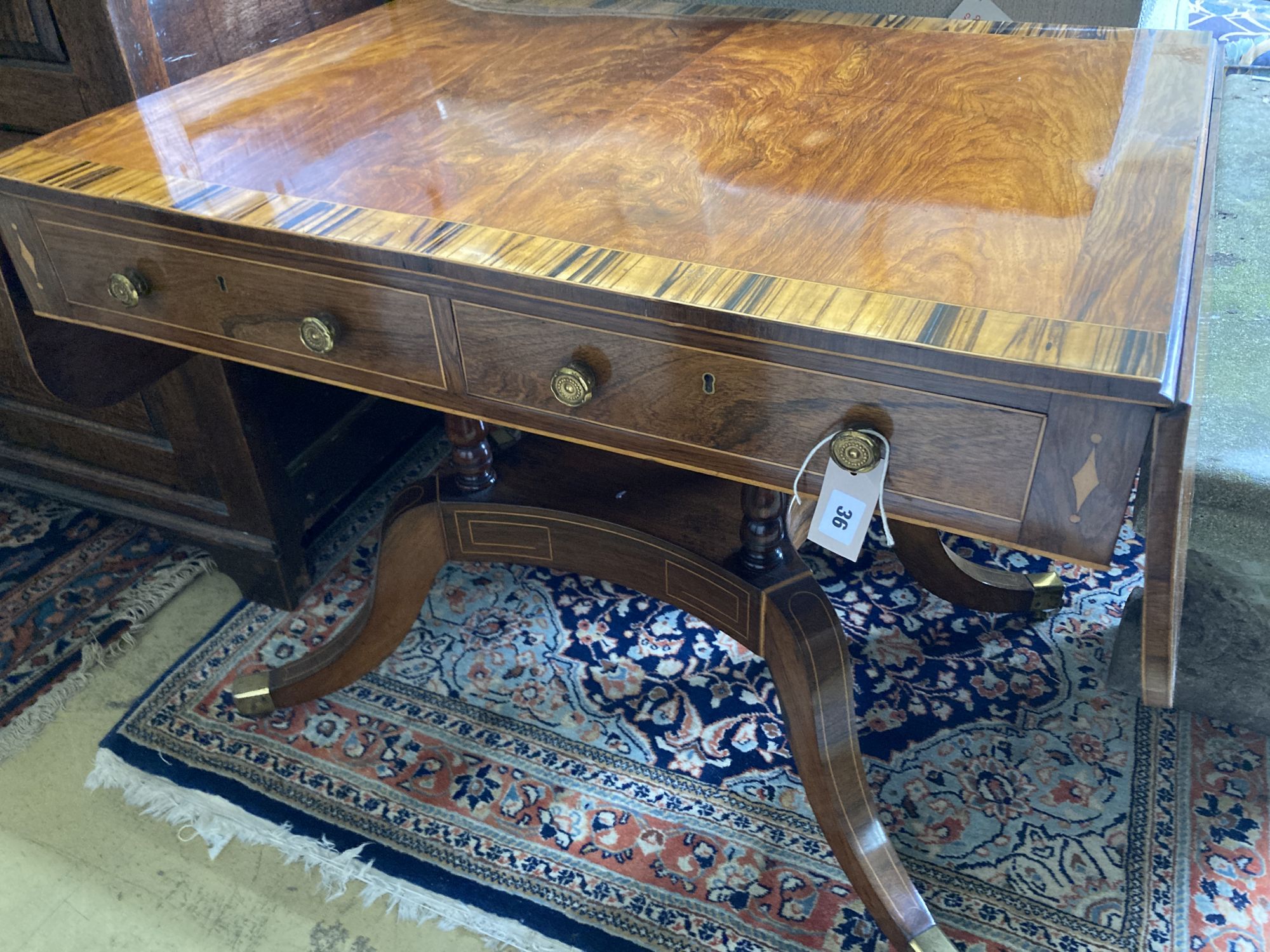 A Regency mahogany sofa table banded in coromandel, W. 3ft. D. 2ft. 2in. H. 2ft 4in.